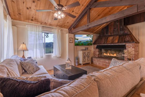 Deerwoode Reserve | Living room, wood beams, fireplace.