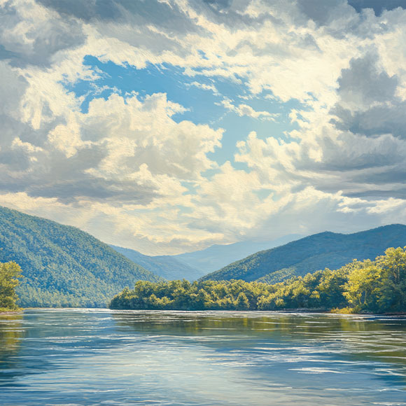 Tranquil lake reflecting a tree-lined shoreline and forested hills beneath a partly cloudy blue sky.